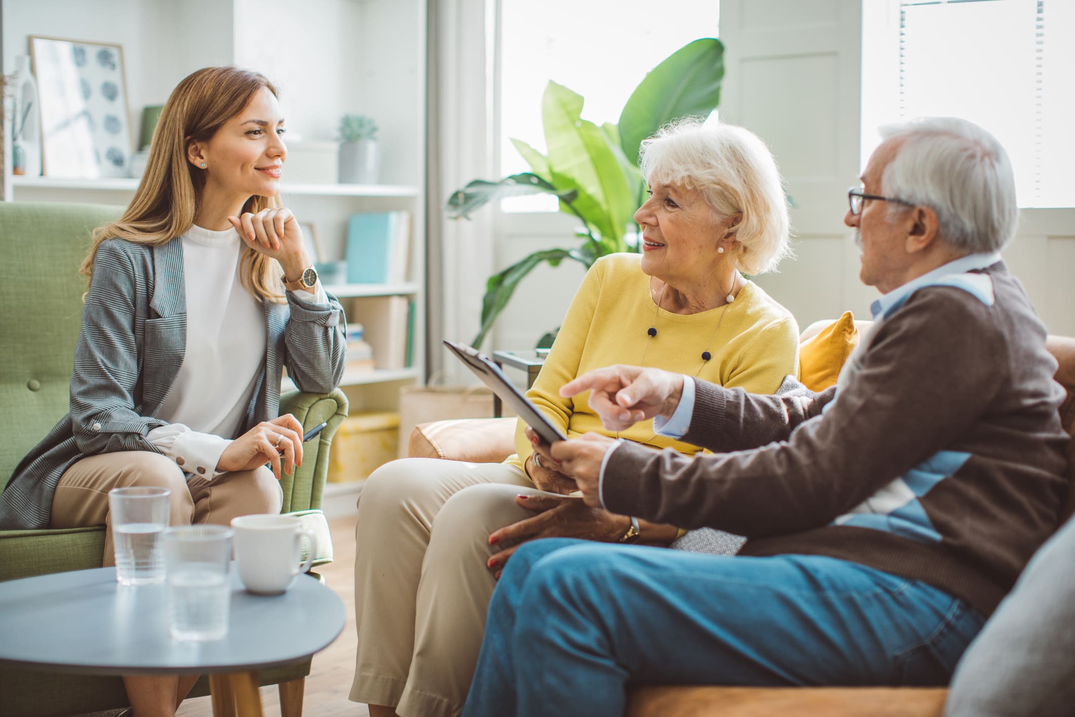 Senior couple consulting with female advisor